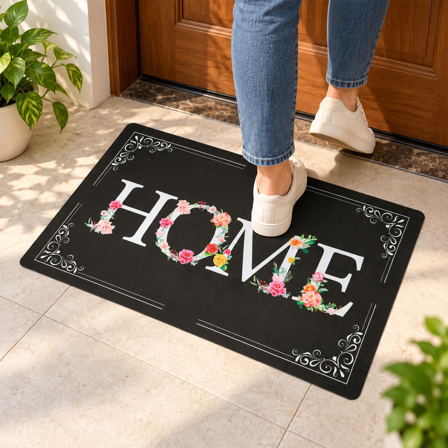 A person steps on a black rectangular mat with a white and floral HOME design at an entryway, from a slightly different