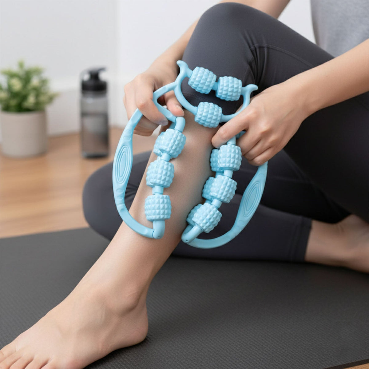 Person using double wheel massager on leg