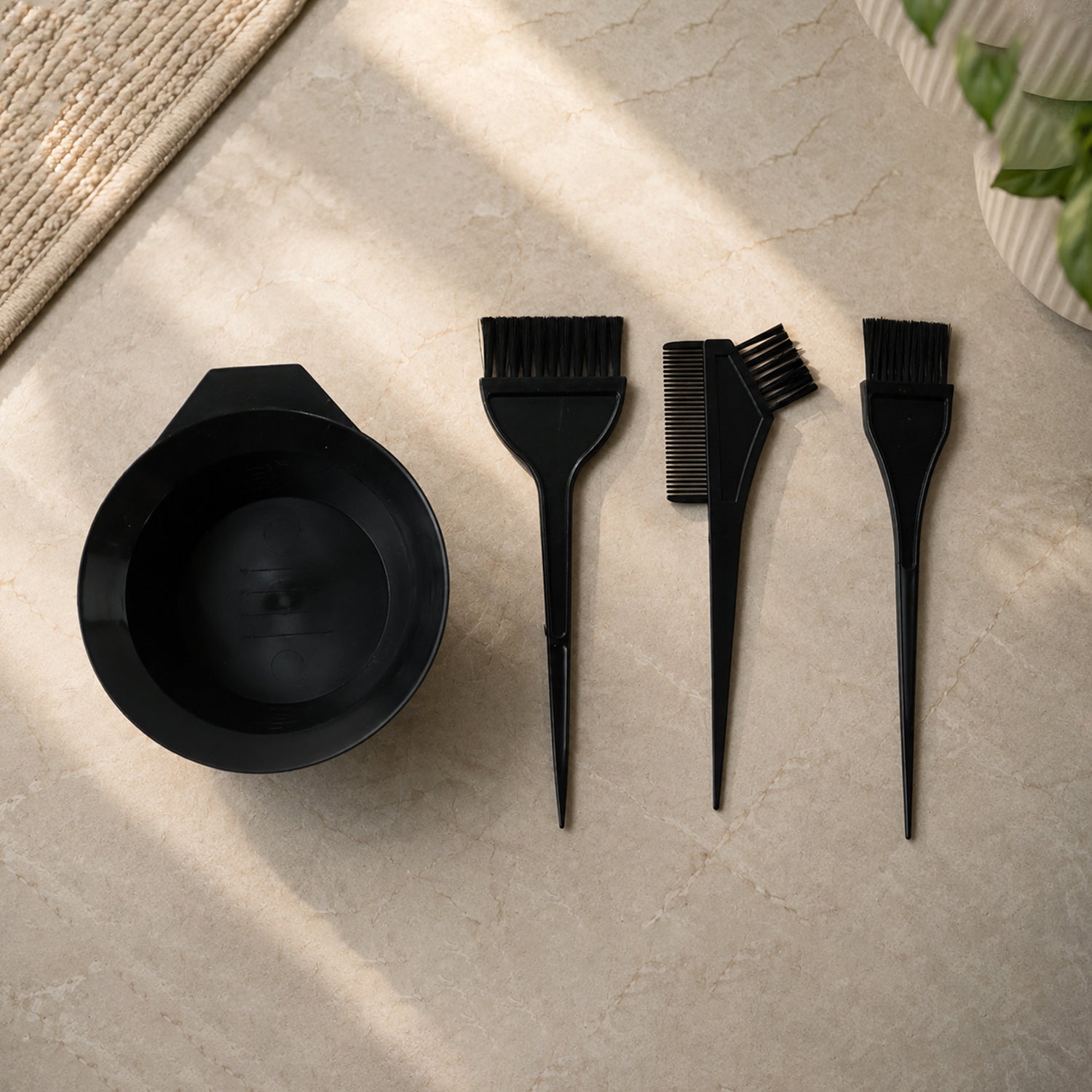 Tools for hair dyeing: brushes, mixing bowl, and comb in black