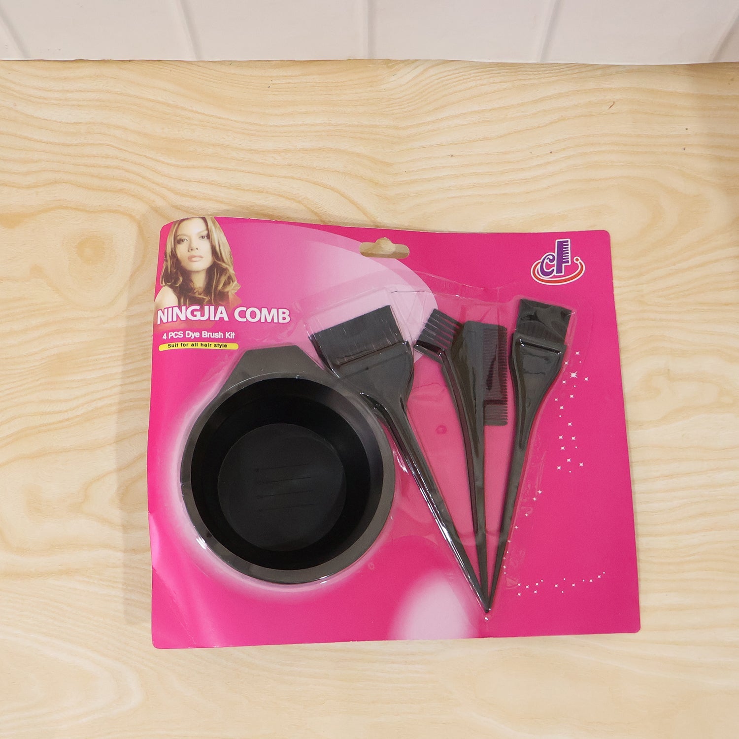 Hair coloring kit laid out showing brushes, bowl, and comb in black