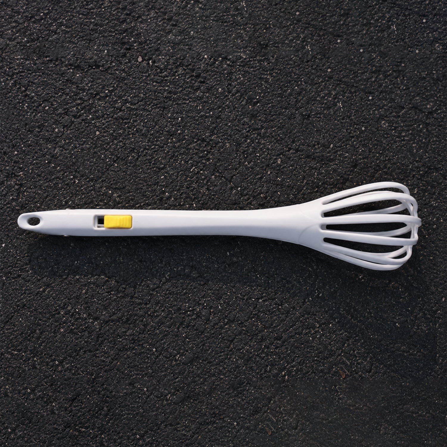 White manual egg beater with ergonomic handle for comfortable use.