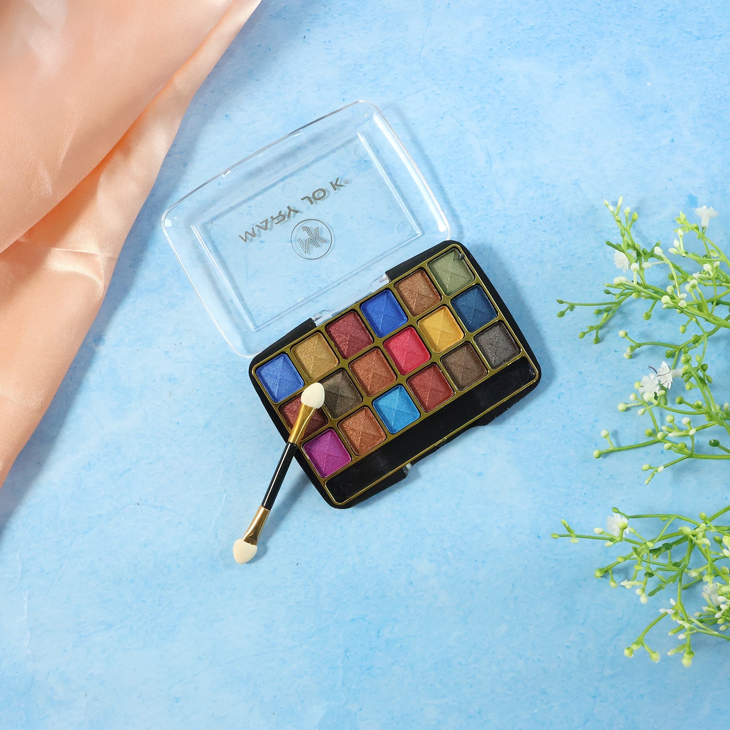 Close-up of shimmer pink and purple eyeshadow shades in palette