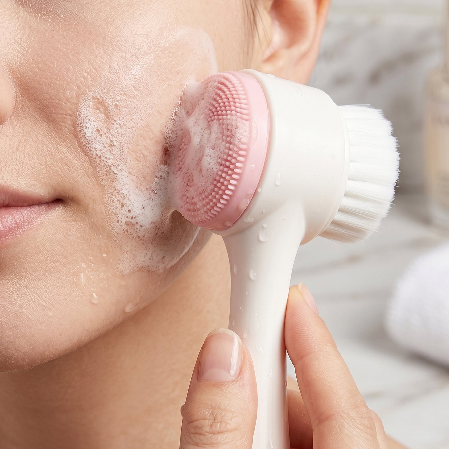 Facial brush on a mirror showing its portable design