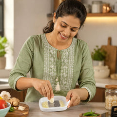 Garlic ginger grater plate with grated garlic on the stainless steel teeth