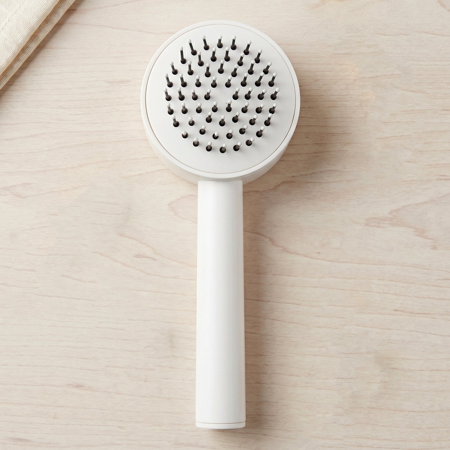 Person combing hair with the detangling air cushion brush
