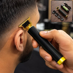 A hand holds a black and gold hair trimmer to a man's temple, with a small inset showing the trimmer, charger, and comb
