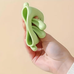 Close-up of bear shaped silicone faucet handle extender on bathroom sink