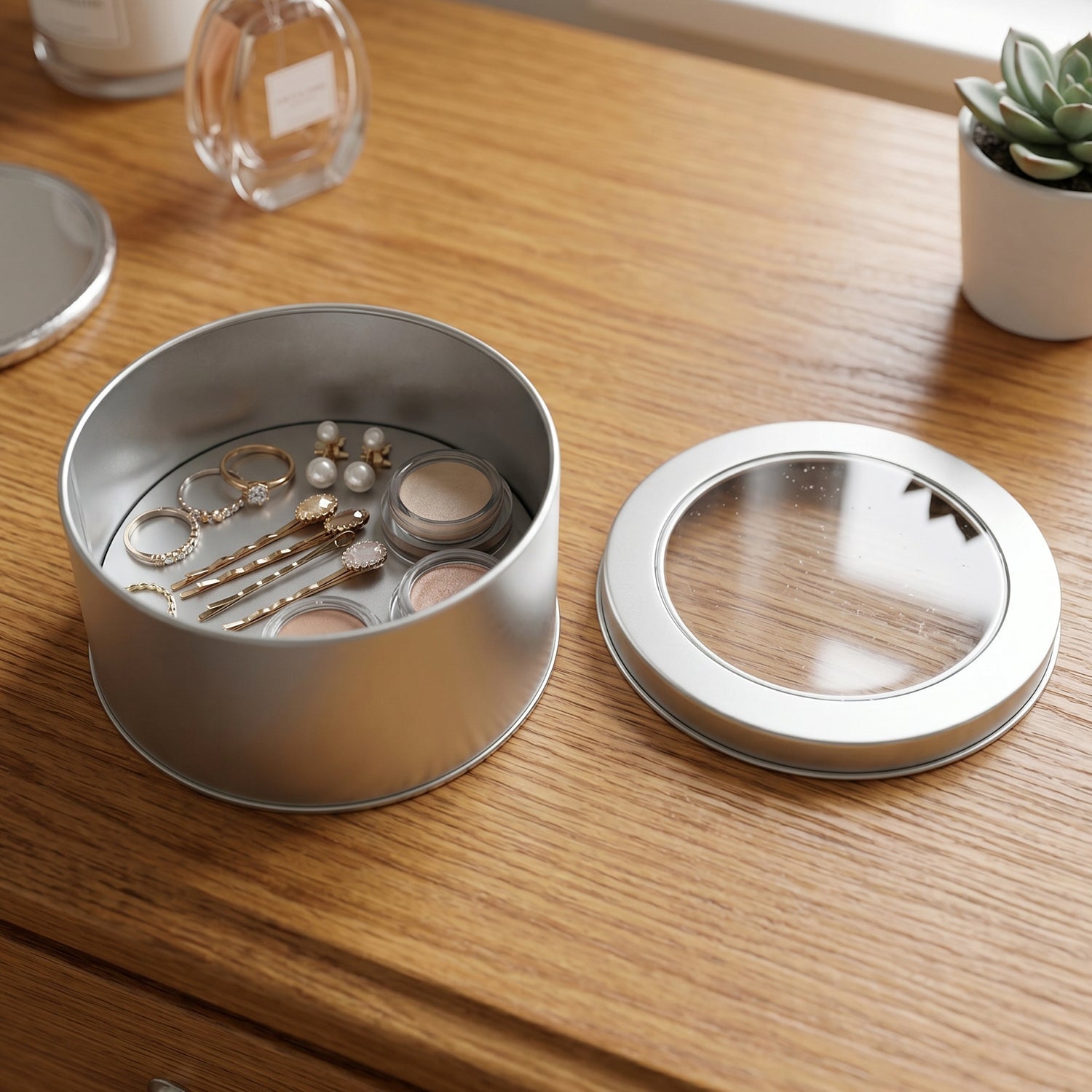 Silver round storage tin with transparent lid, ideal for gifting and compact storage.