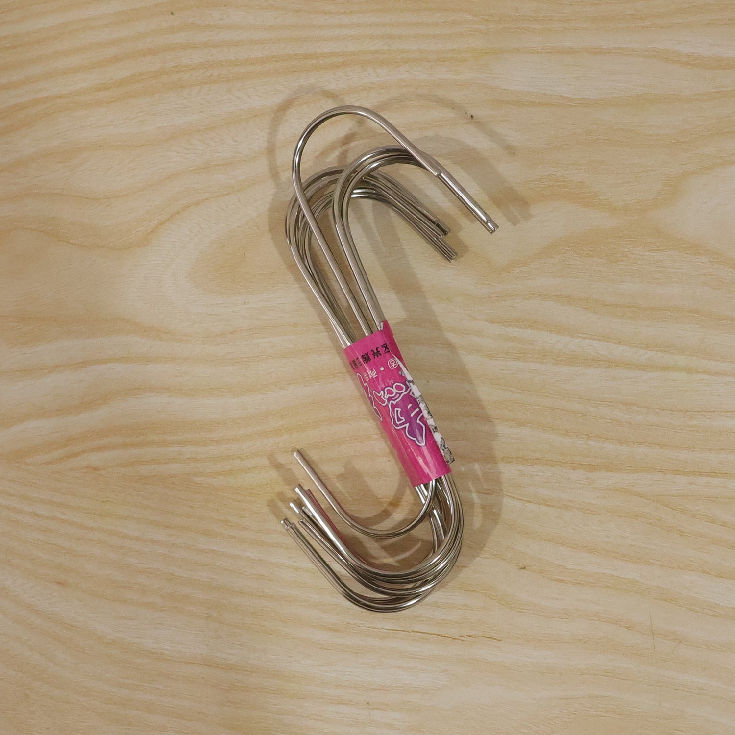 Versatile S hooks hanging from a rack, holding bags and supplies.