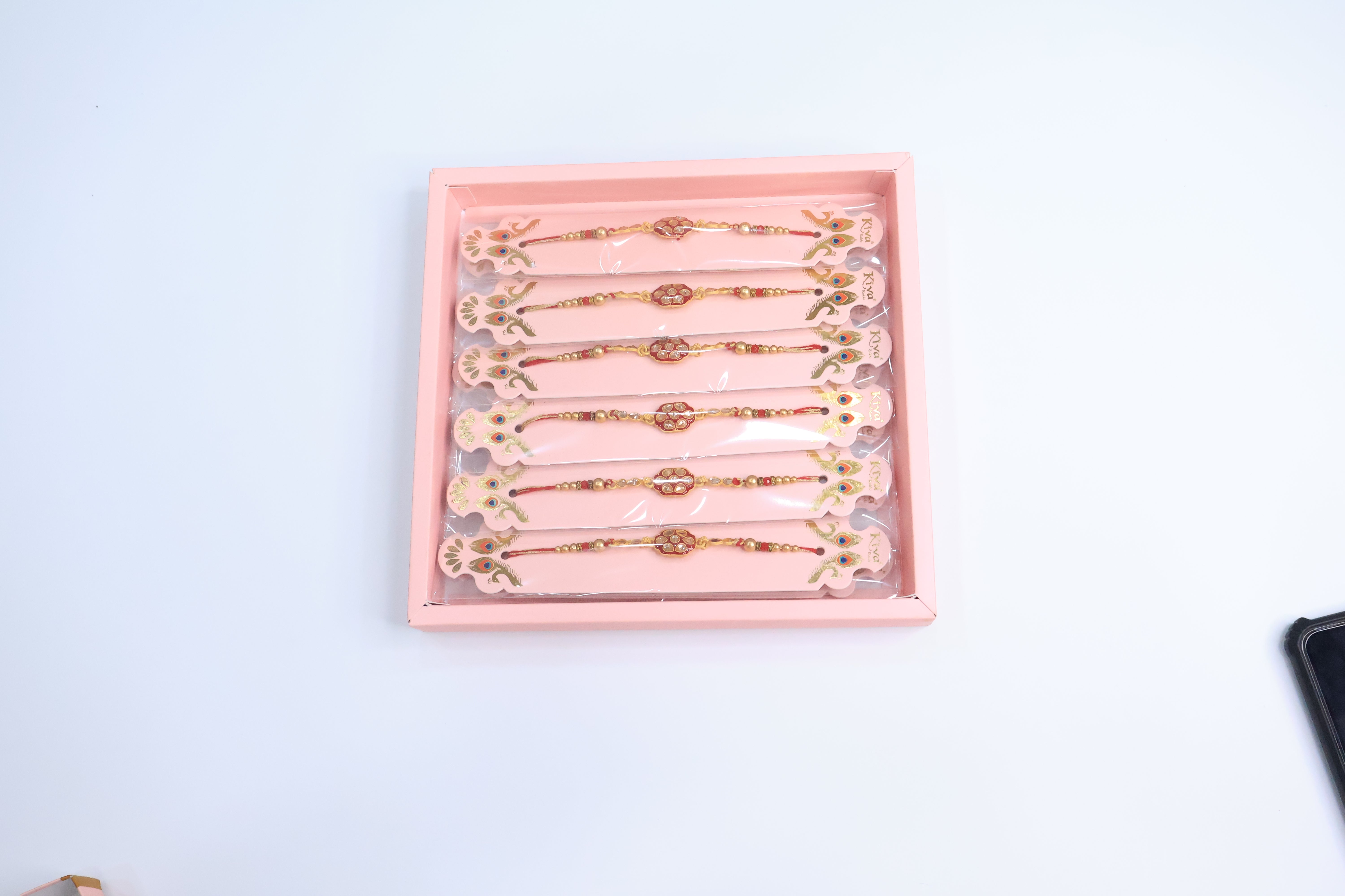 12 Pc Royal Kundan Rakhi Set with Red Enamel Work and Golden Beads â€“ Premium Traditional Gift Box for Raksha Bandhan