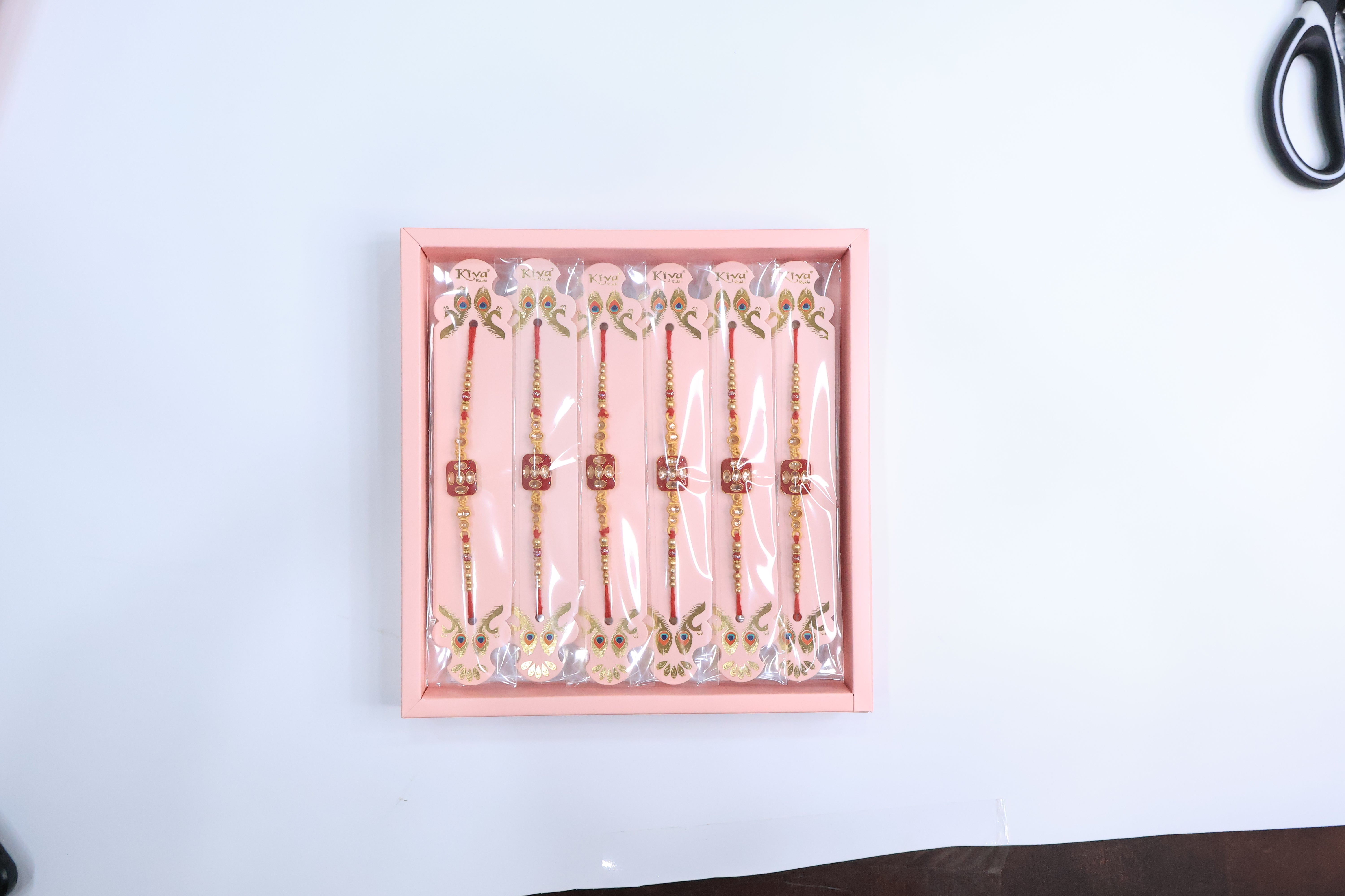 12 Pc Square Kundan Rakhi Set with Red Enamel Dial and Golden Beads â€“ Premium Designer Rakhi Gift Box for Raksha Bandhan