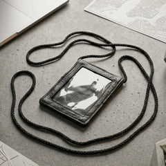 Close-up of the black PU leather neck wallet showing the clear ID window