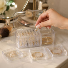 Acrylic jewelry storage box showcasing multiple compartment designs for rings, earrings, and necklaces.