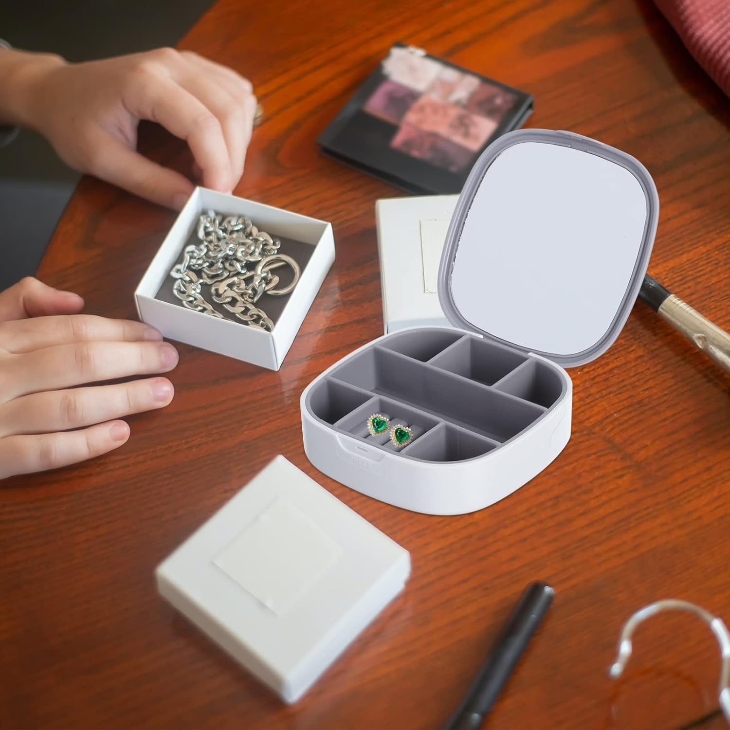 Plastic jewelry storage box shown in use