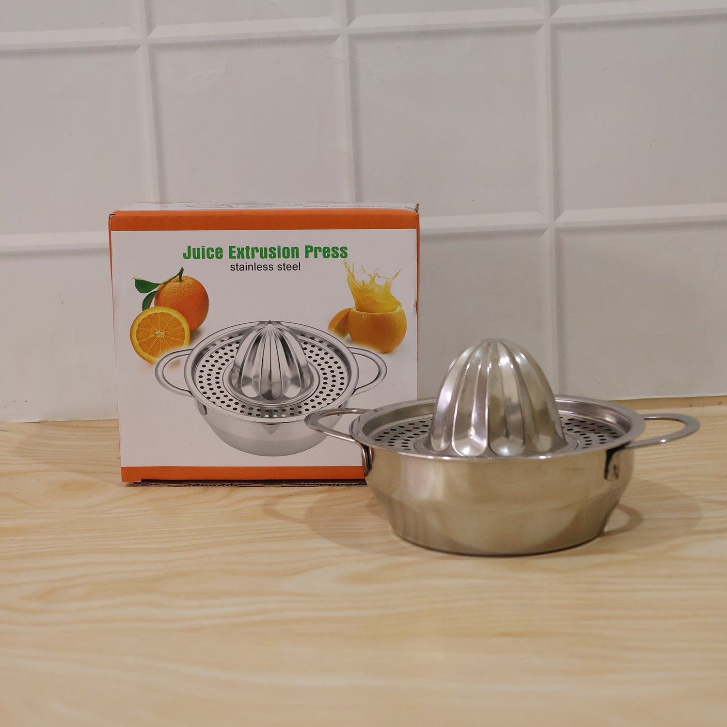 Our stainless steel manual citrus juicer shown in a vibrant kitchen setting.