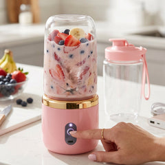 Lightweight pink portable electric blender with 2 cups for travel and outdoor use