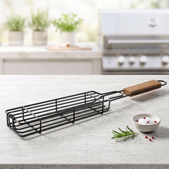 Grill basket filled with vegetables over hot coals