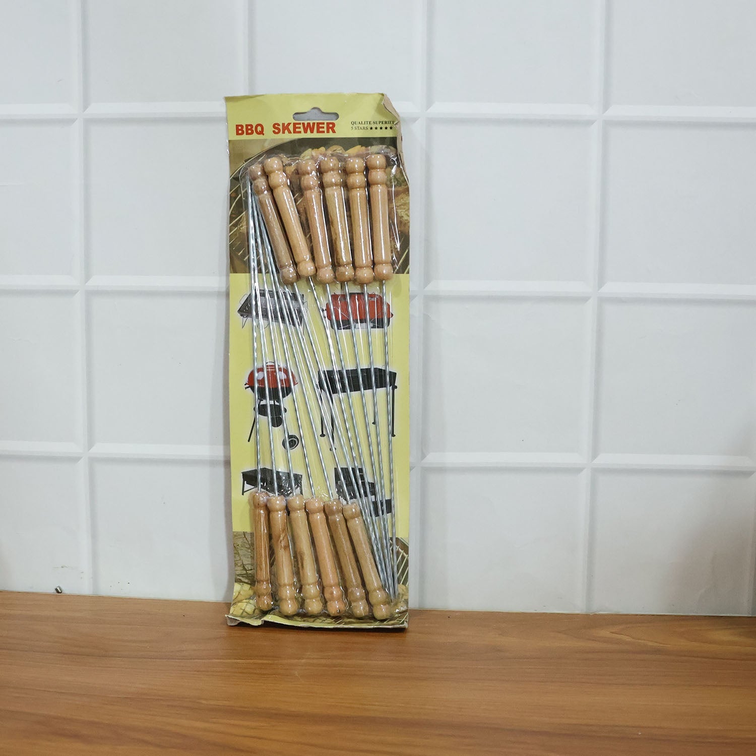 Barbecue skewers in use with grilled food on them over fire