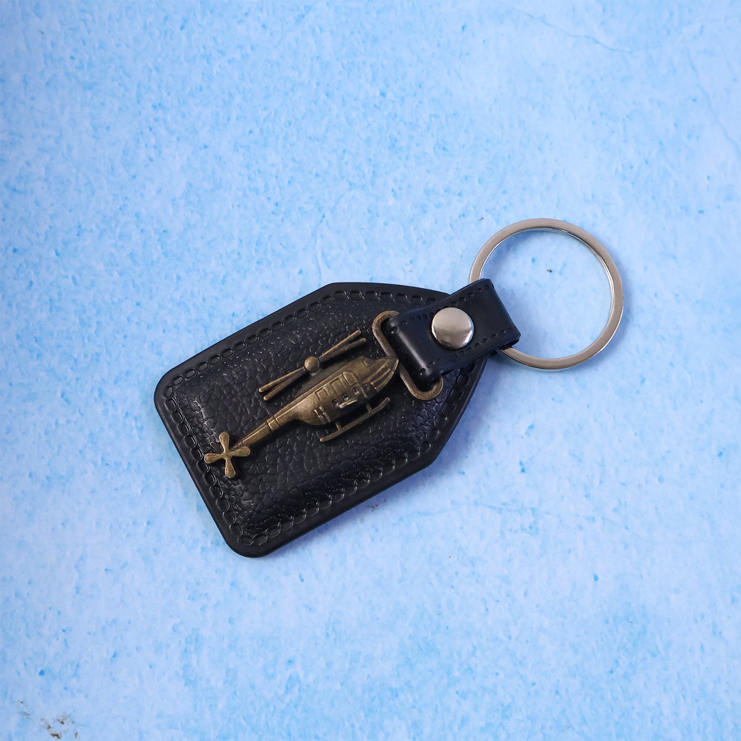 Leather finish base and metal sword emblem keychain hanging
