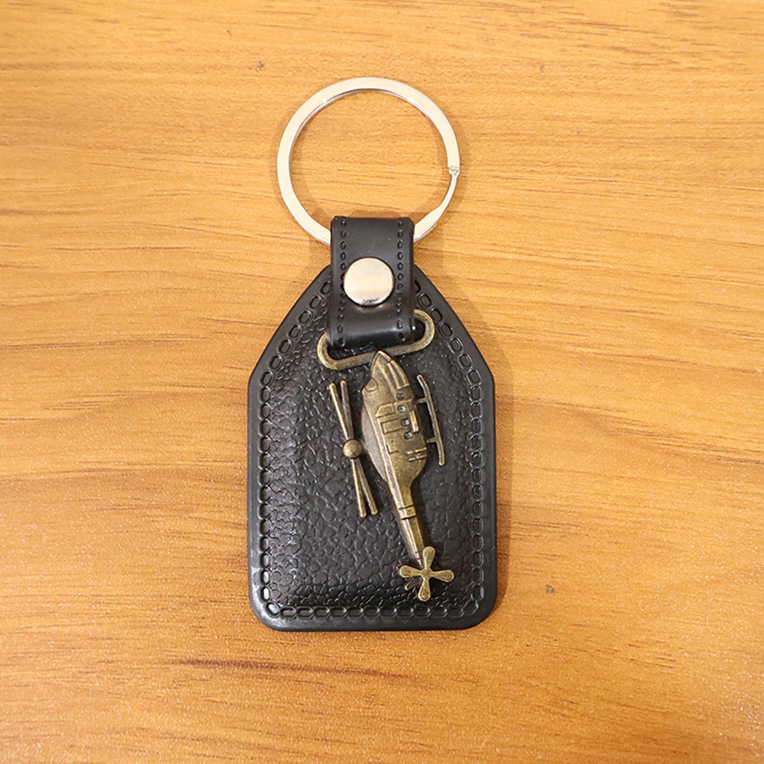 Full display of leather and metal sword emblem keychain