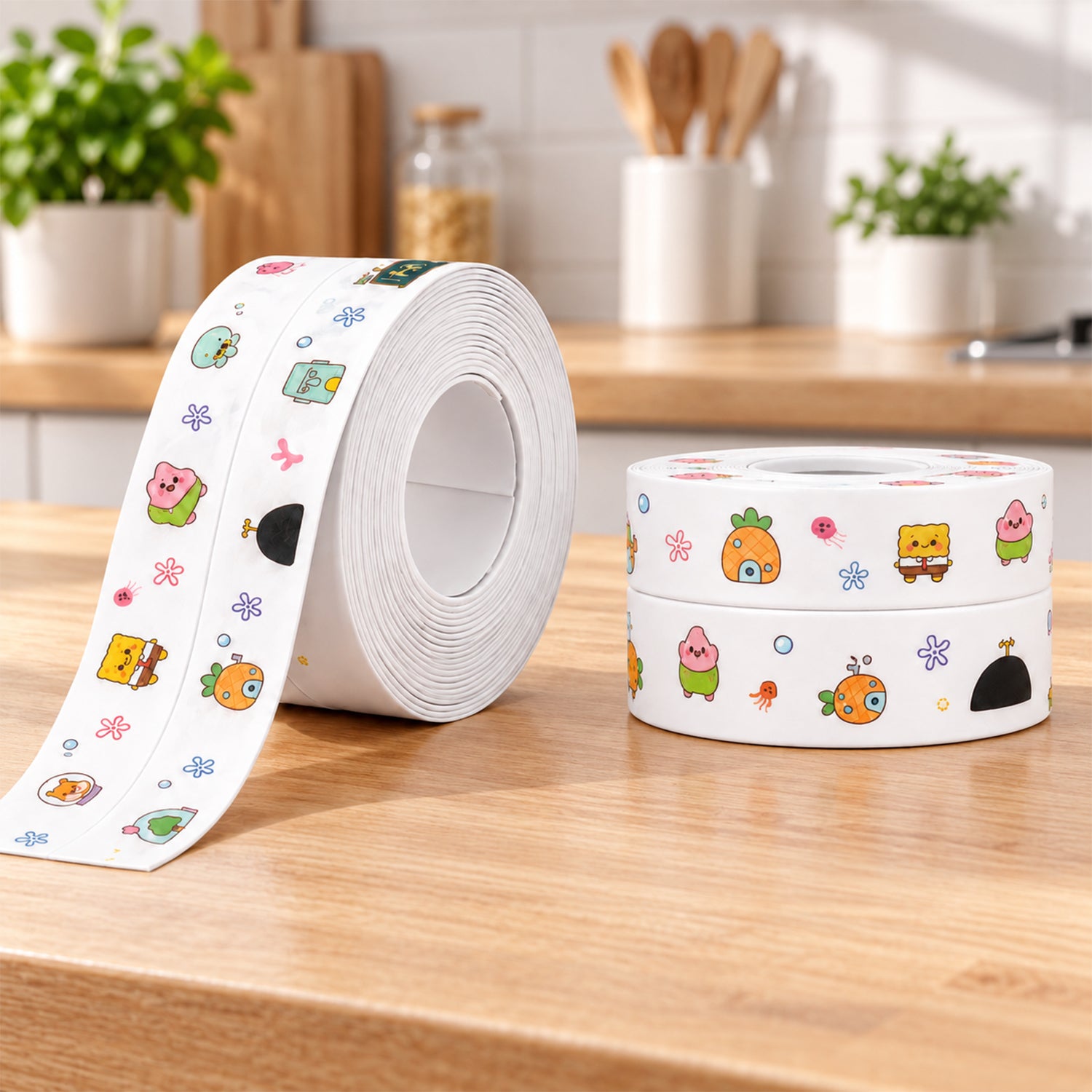 A roll of white sealing tape with colorful cartoon characters sits next to two smaller stacked rolls on a wooden counter.