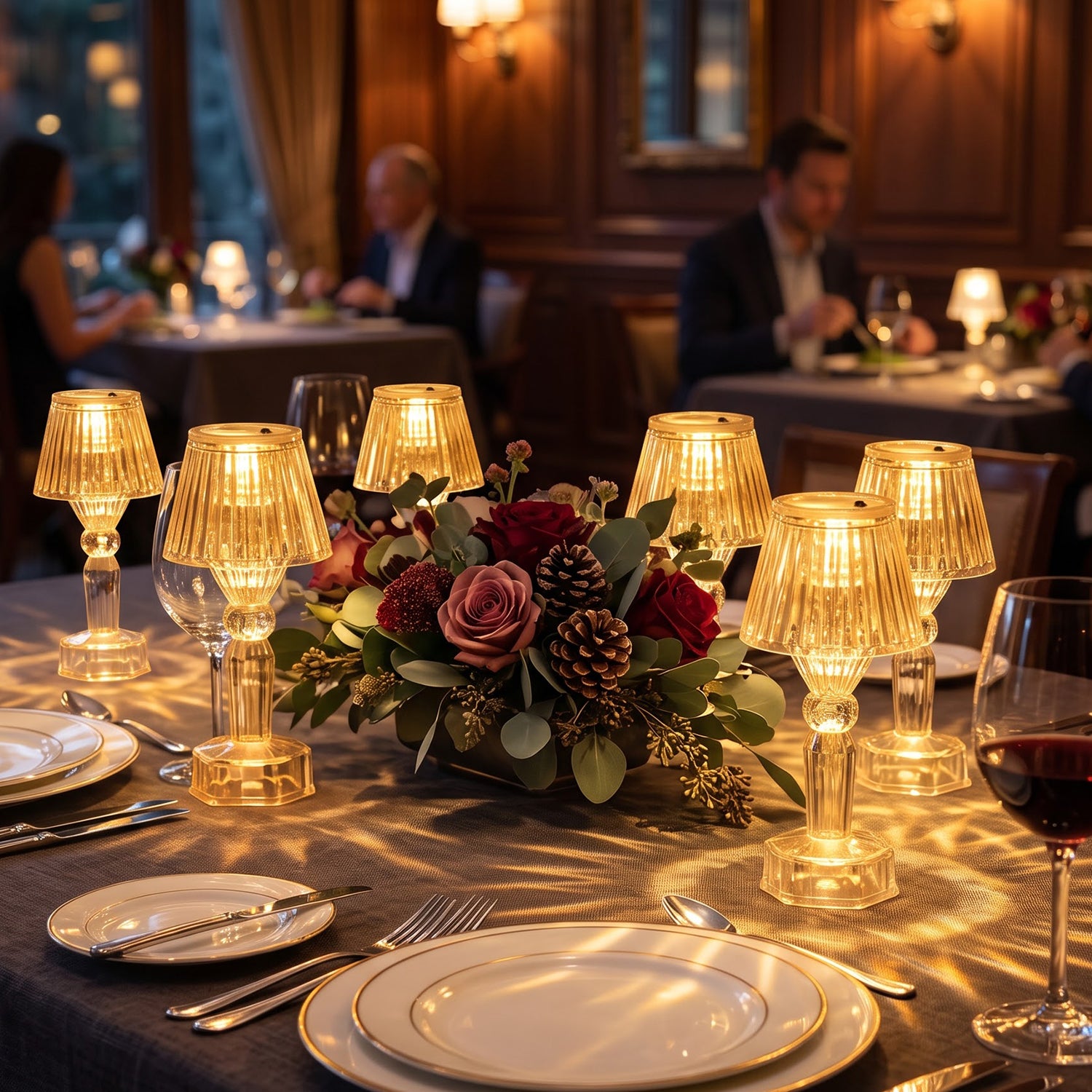 A luxurious restaurant setting with multiple clear acrylic LED lamps casting light patterns on a dark tablecloth.