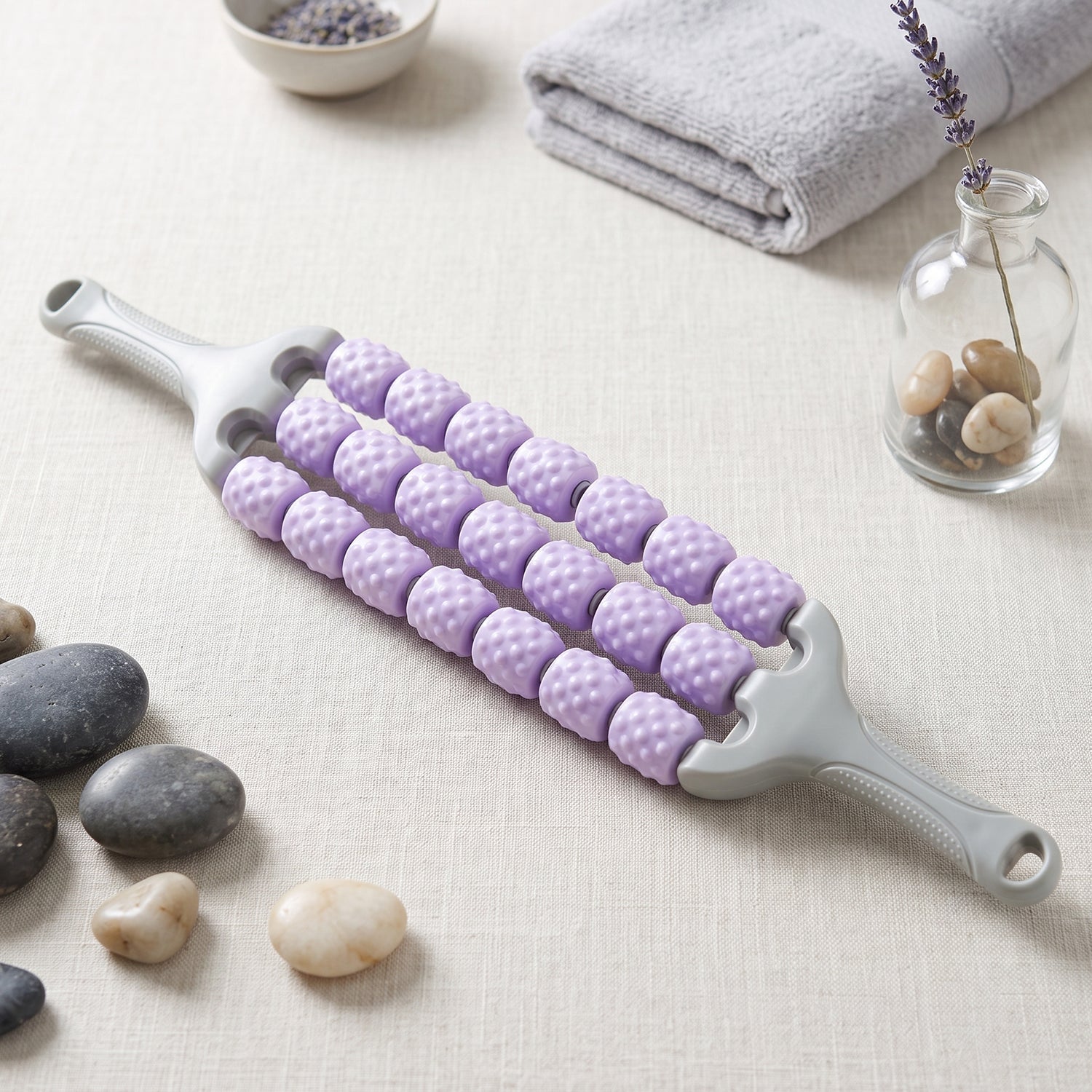 Rolling the massage stick along the thigh muscles