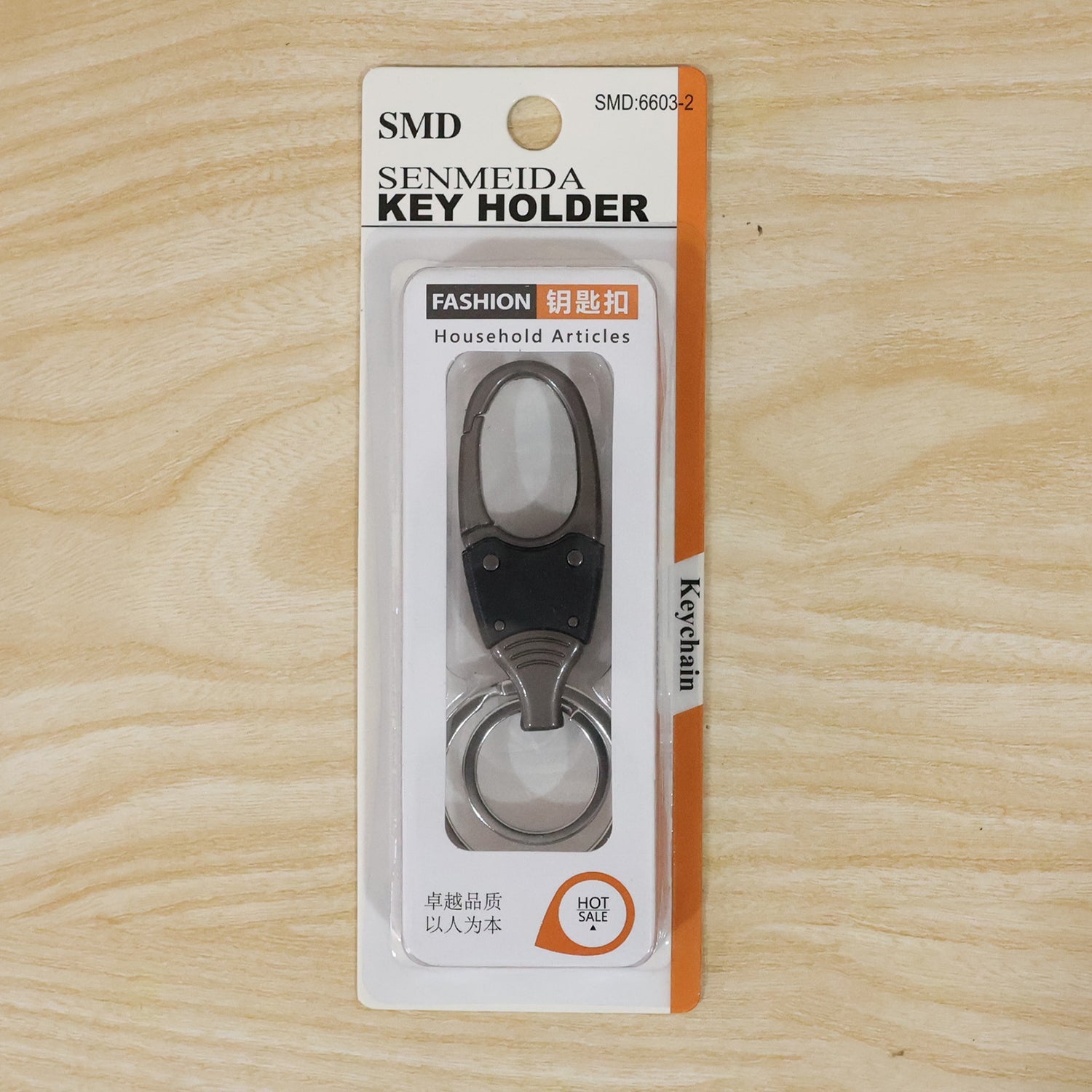 Metal key holder with rotating swivel on a white background