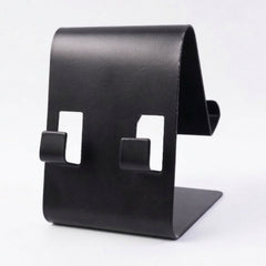 Black metal phone stand holding tablet, side view