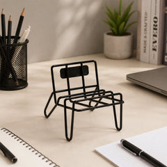 Phone resting in the chair shaped stand