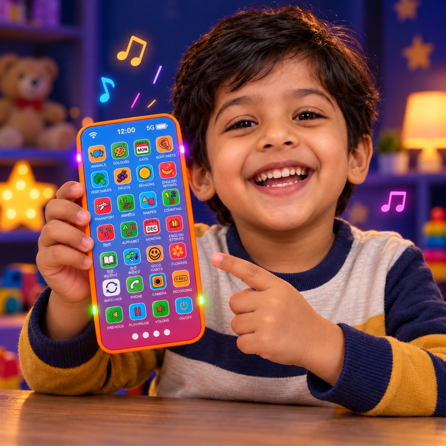A young boy smiles broadly, pointing at a bright orange and blue toy phone with colorful app icons and glowing side lights.