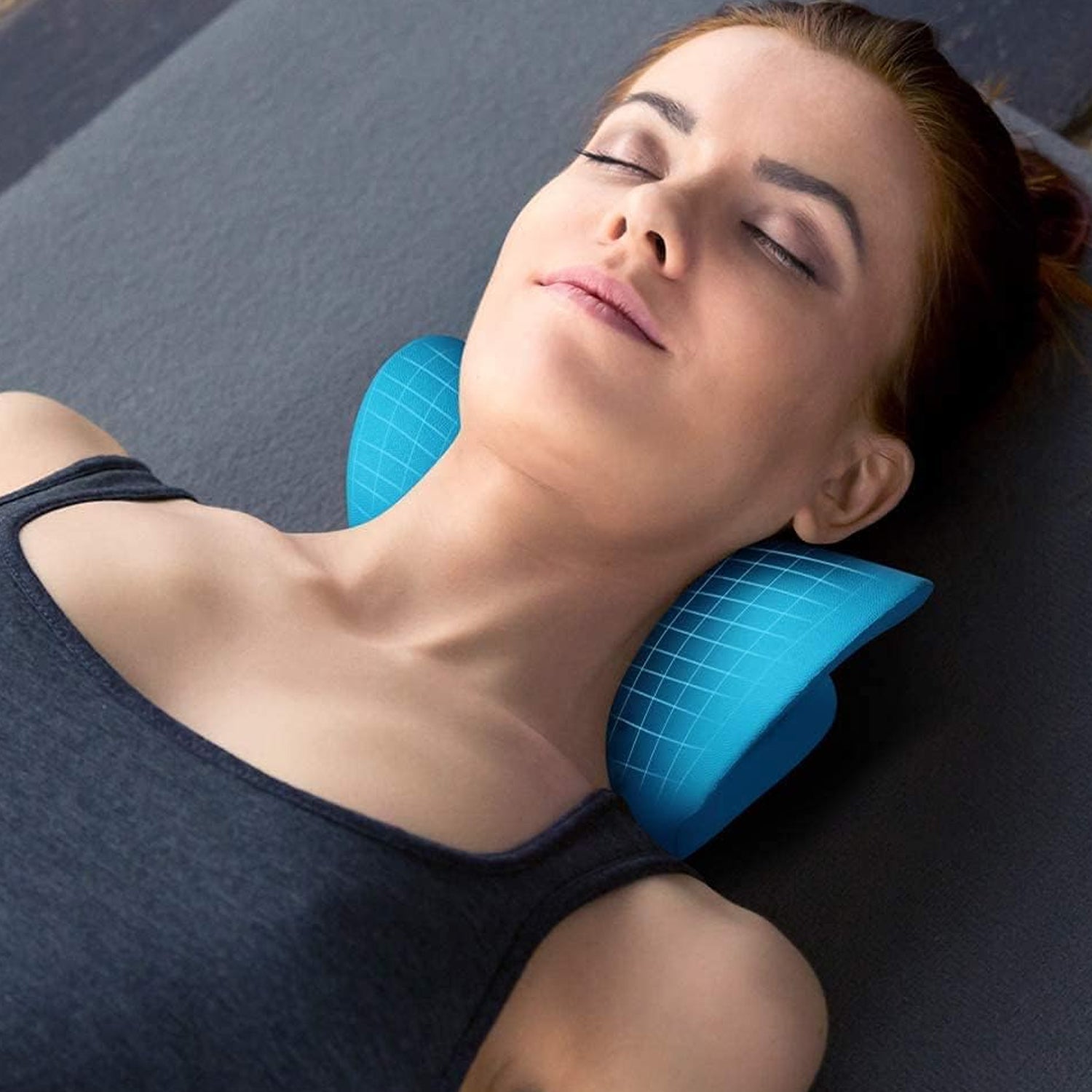 Ergonomic cervical pillow supporting neck and shoulders, blue color