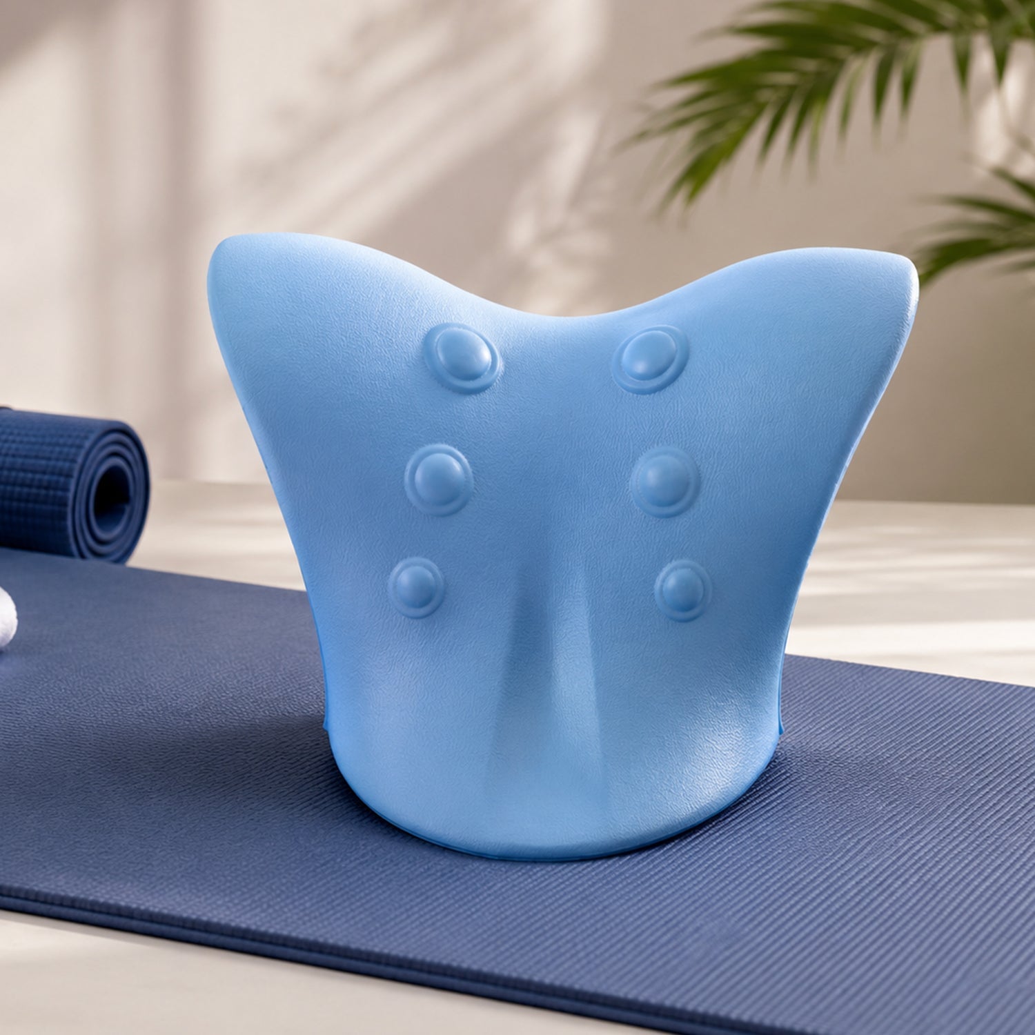 Different angles of blue neck and shoulder relaxer pillow