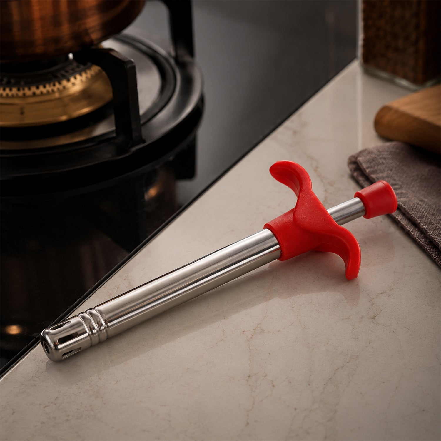 Gas lighter igniting a stove burner