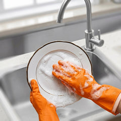 Close-up of orange rubber gloves for dishwashing