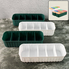 Four 5-compartment drawer organizers stacked with various items like socks and underwear