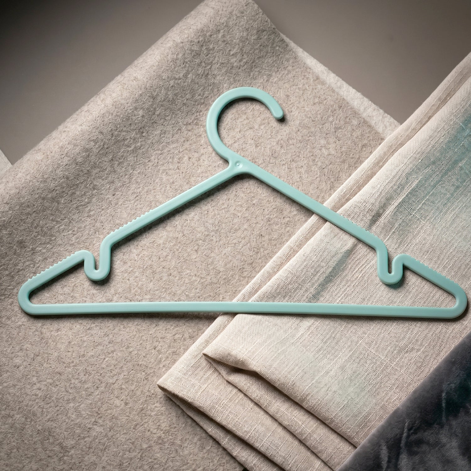 Plastic hanger holding shirt and dress
