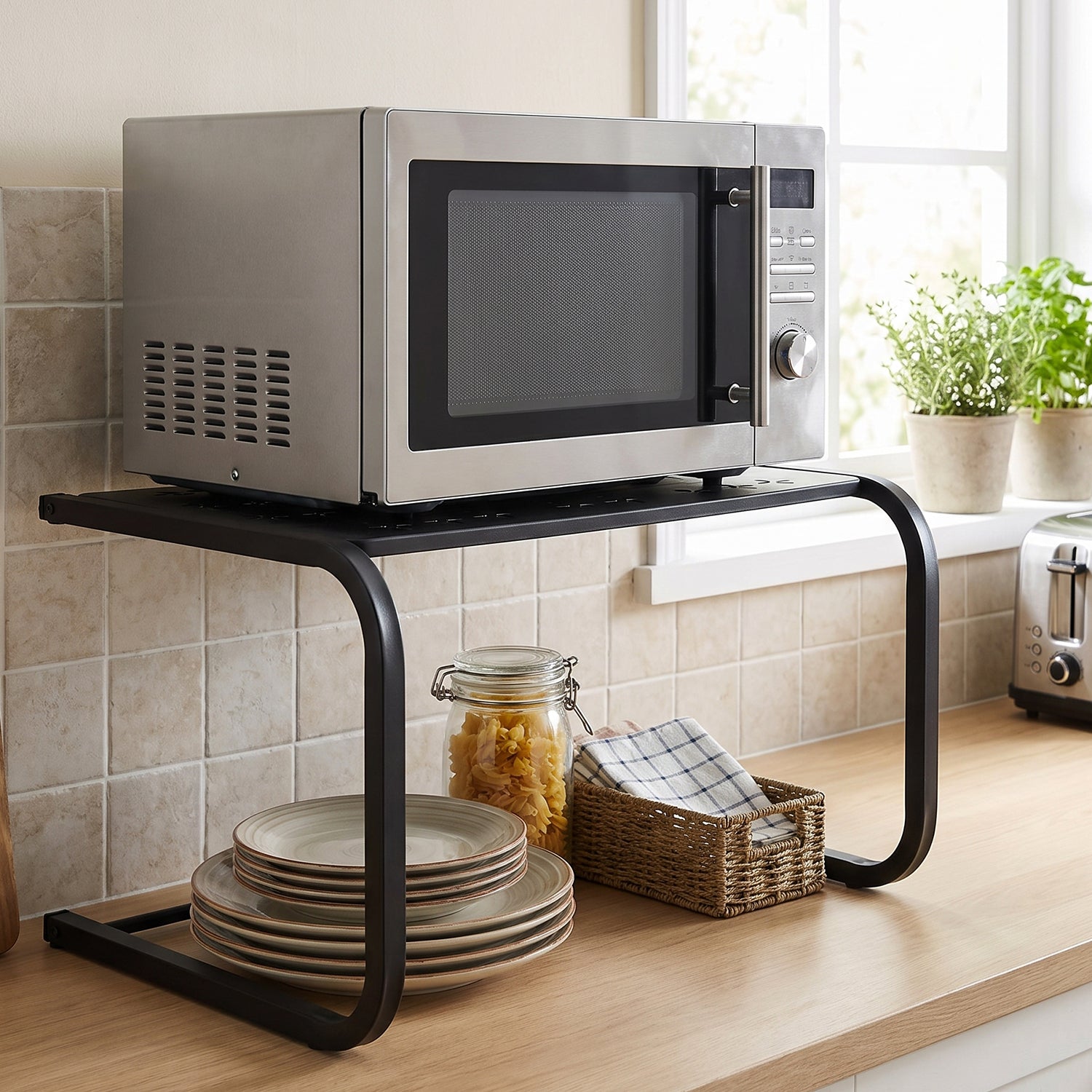 Microwave stand with utensils stored on the lower shelf