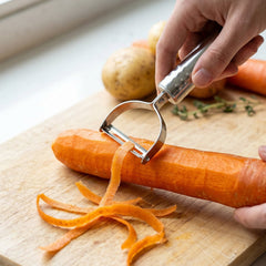 Hand holding a vegetable peeler