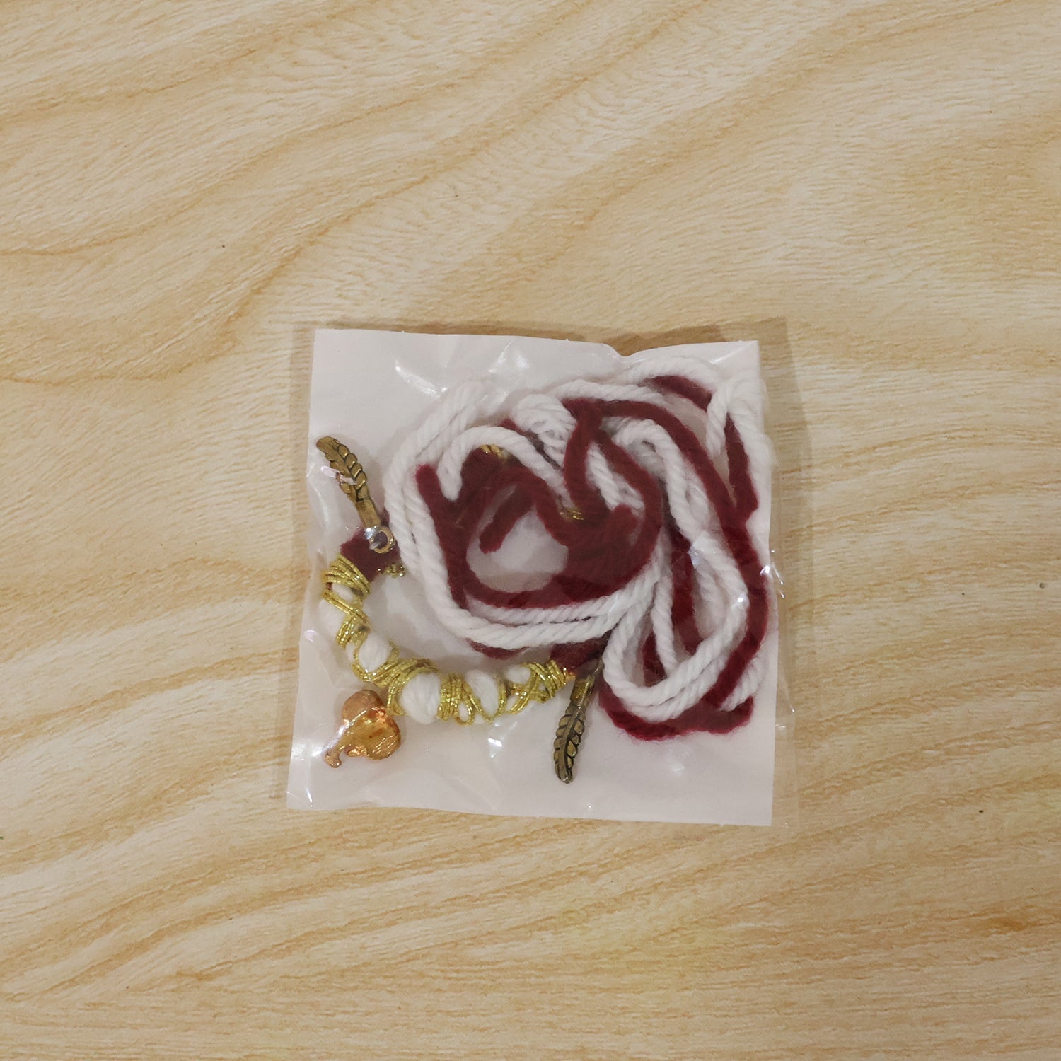 Decorative Ganesh Feather Thread Rakhi on hand