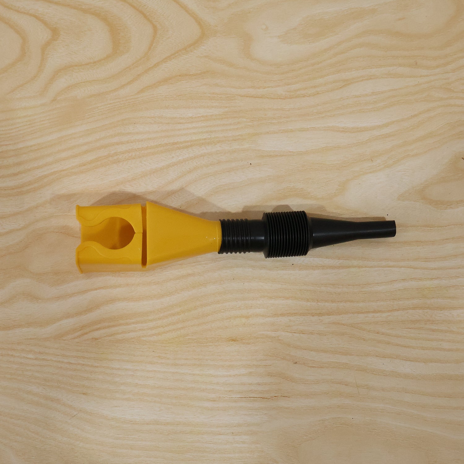 Hand holding the flexible plastic funnel ready for use.