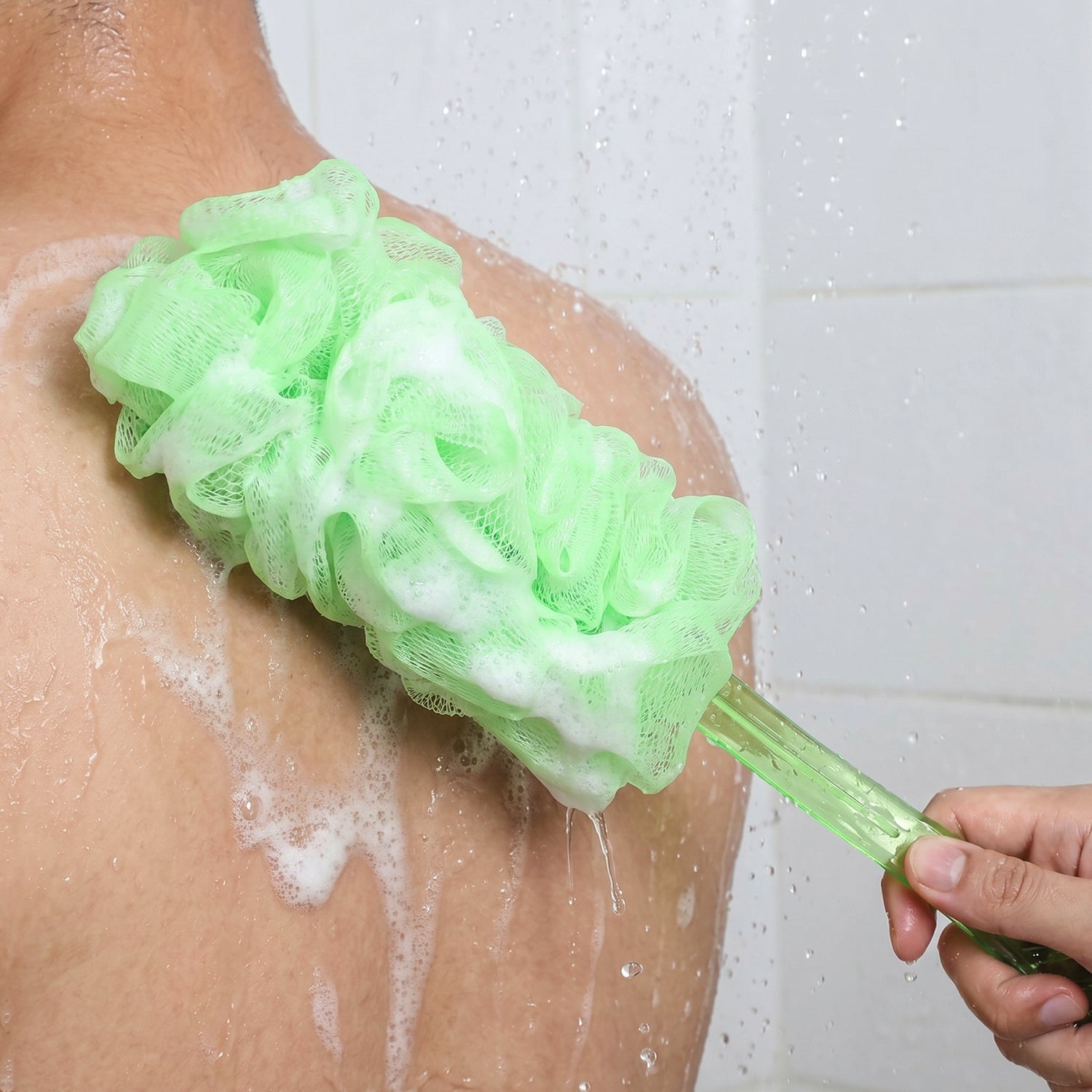 Shower body scrubber with long handle in use context