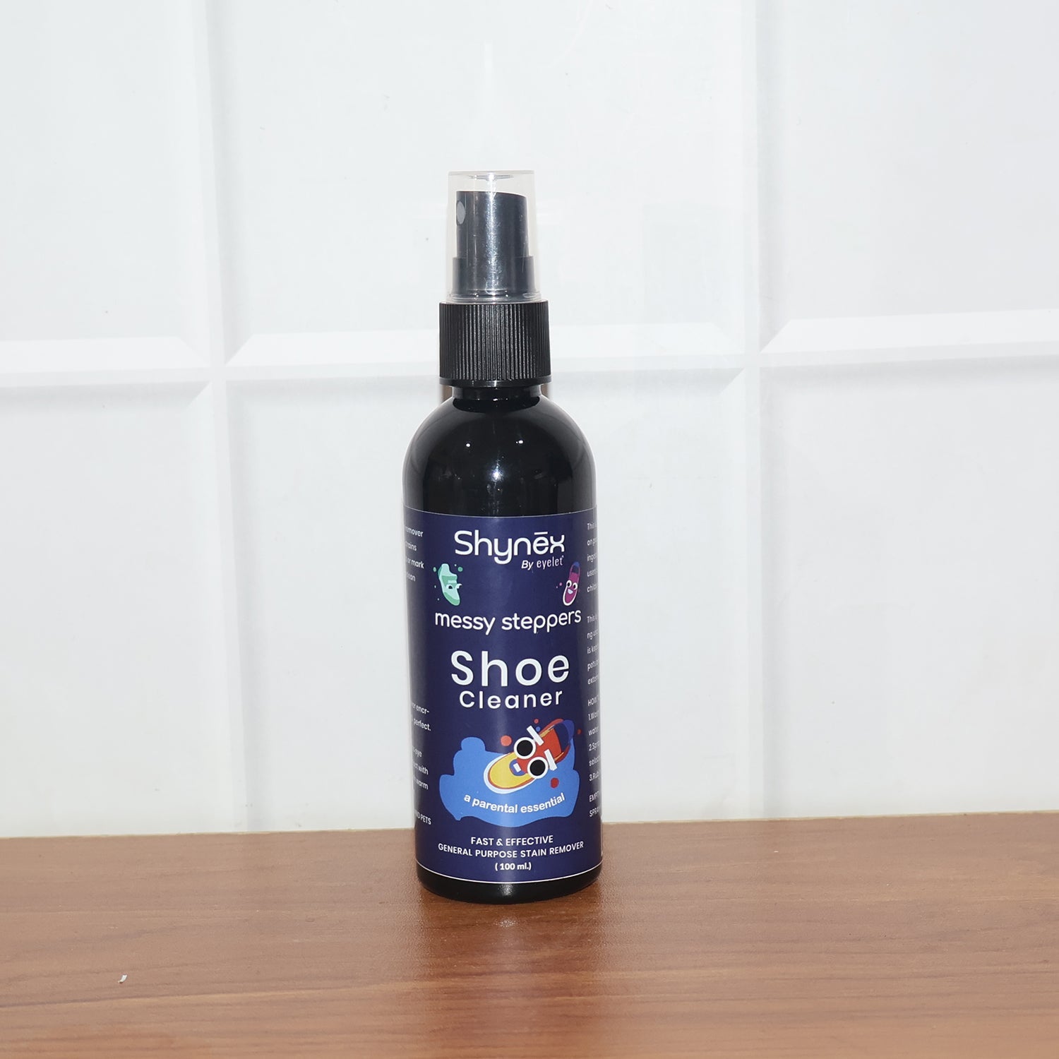 Person applying Messy Steppers Shoe Cleaner Spray on sneakers