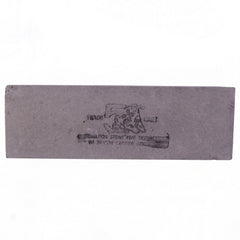 A rectangular gray silicon carbide whetstone with black text is centered on a white background.