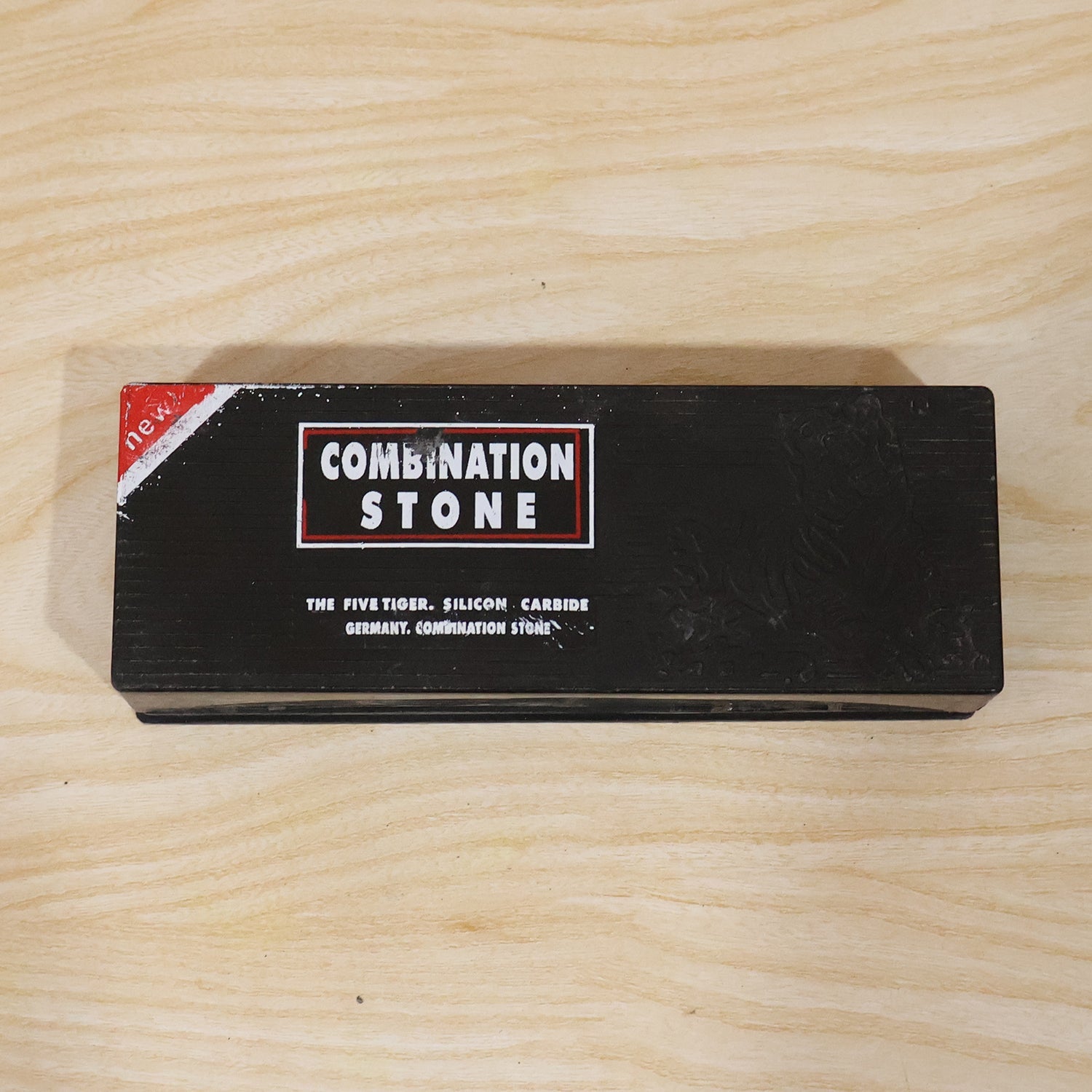 A black box with red and white text for a