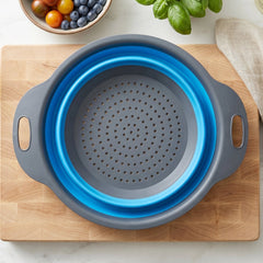 Space-saving silicone colander with side handles for washing fruits and draining pasta.