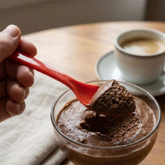 Close-up of a single white heat-resistant plastic spoon