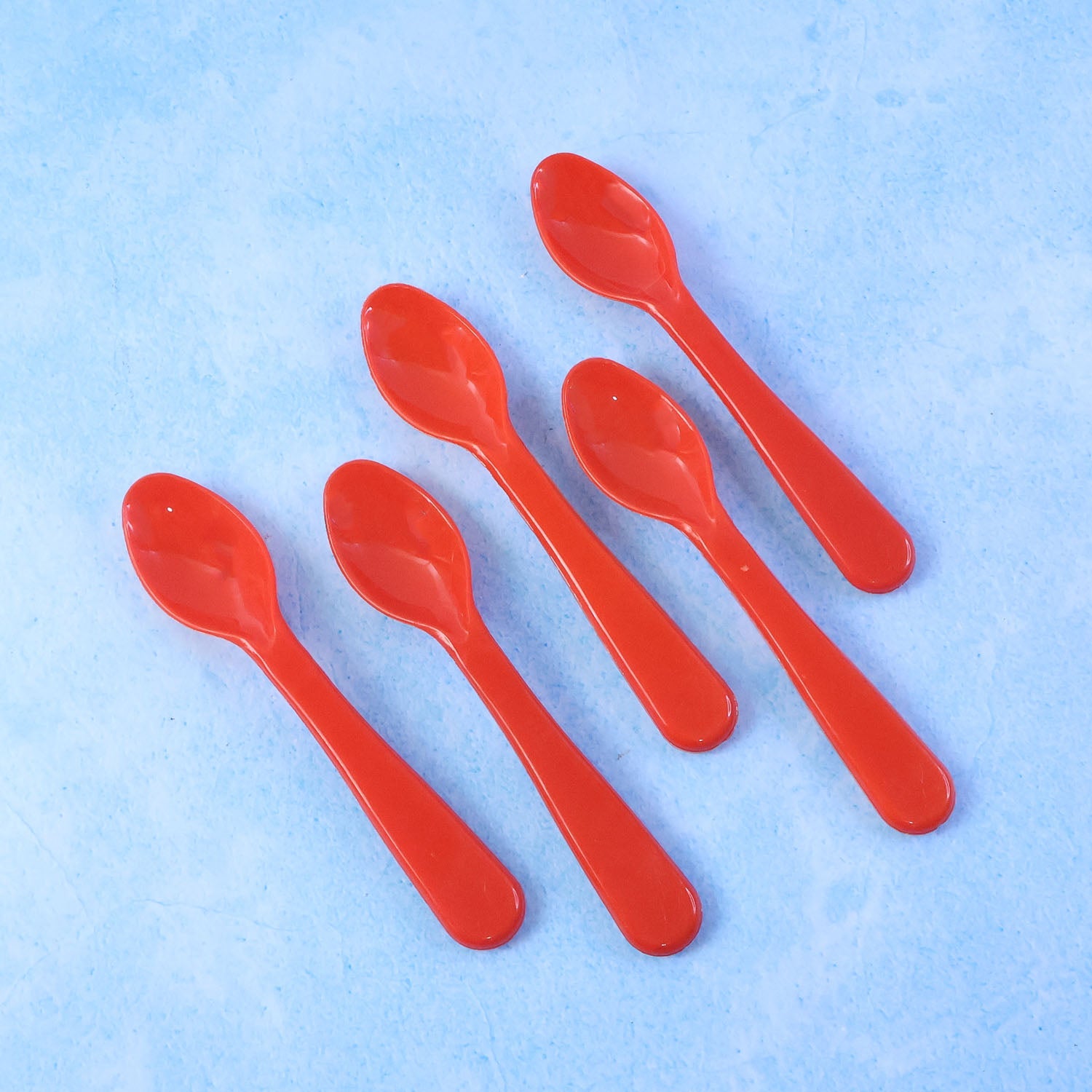 Five plastic spoons sealed in clear retail packaging