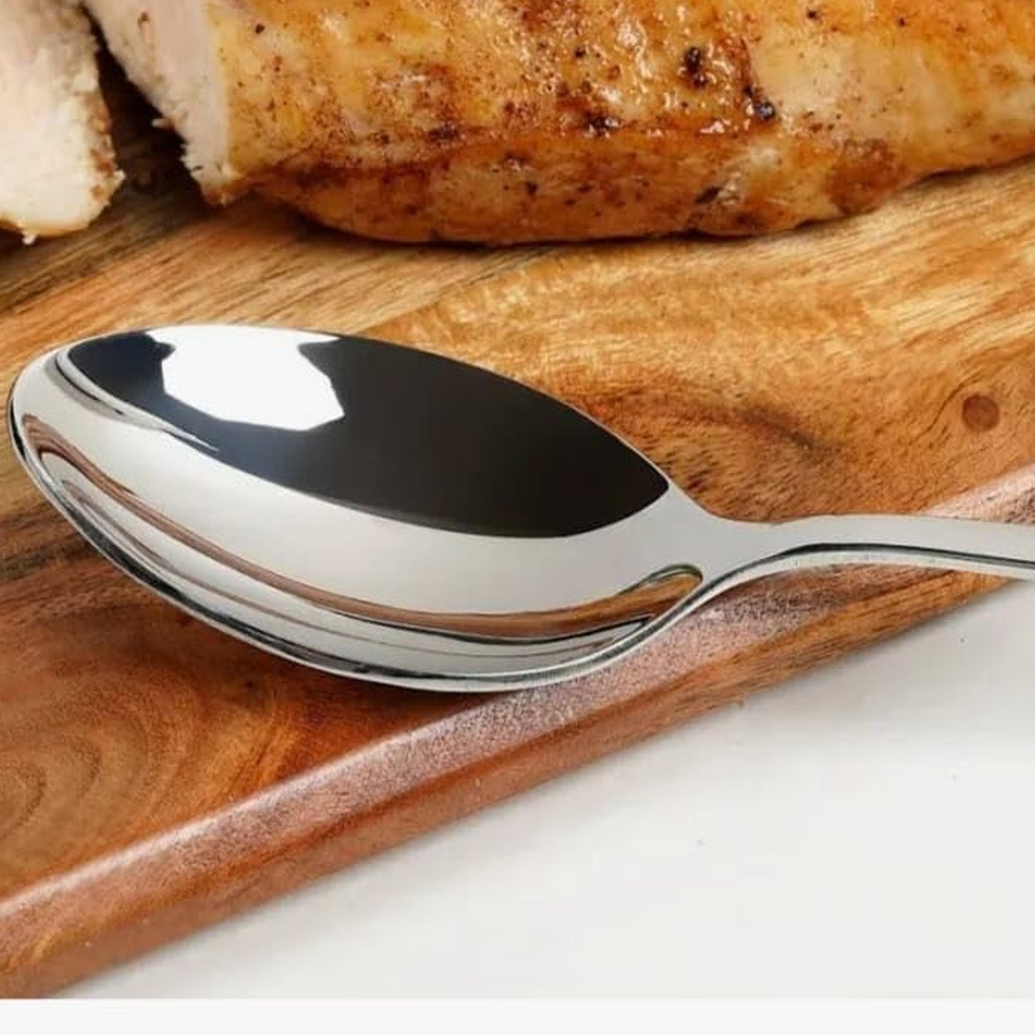 Six baby spoons laid out in a row