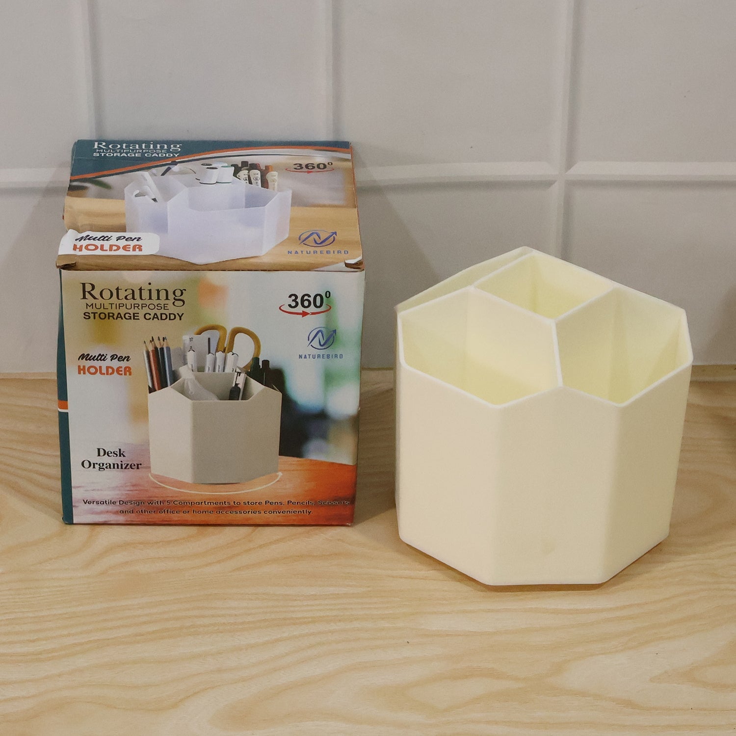 Close-up of compartments holding pens, scissors, and tapes in cream desk organizer